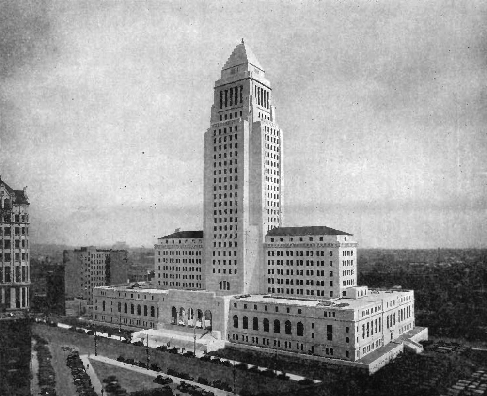 Historic photograph of Los Angeles City Hall from 1931, a rectangular based building, with two wings on top of that and a central pointed tower.
